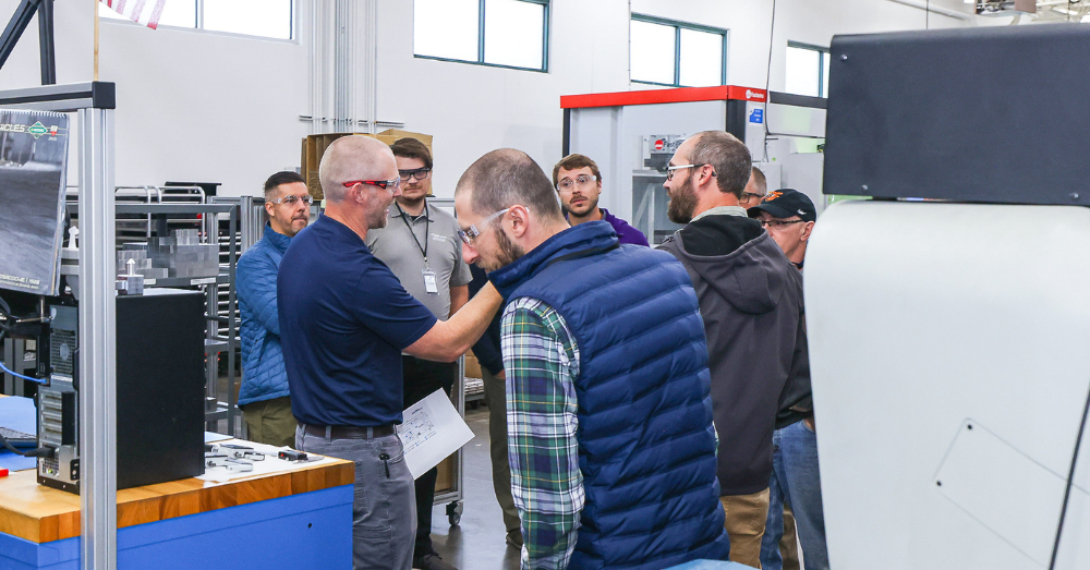 Hirsh employee shows guests one of the automated manufacturing center
