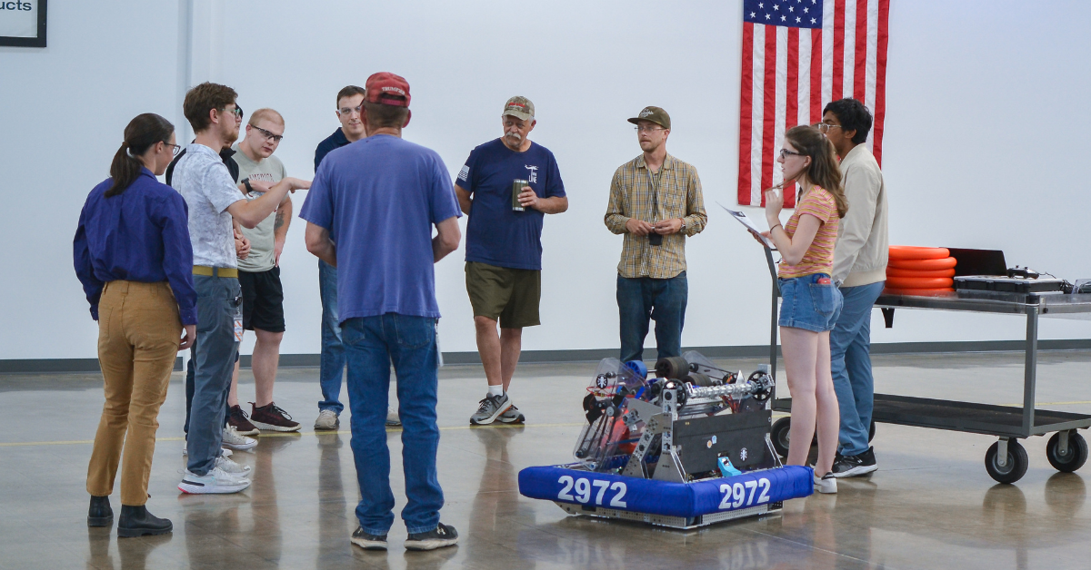 Hirsh engineers and machinists speak with Dawson High School robotics students