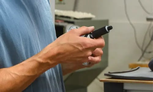 Machinist manually inspects a part
