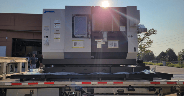 CNC lathe loaded onto flatbed truck