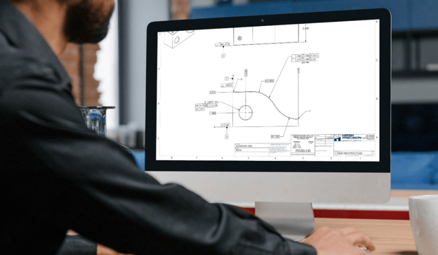 Design engineer reviews GD&T callouts on a part drawing