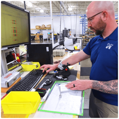 Machinist inputs data into quality control software