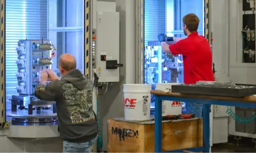 Machinists load parts in Fastems FPC