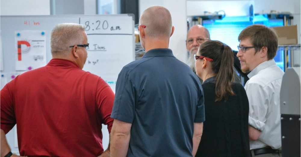 Team members gather for daily Gemba walk