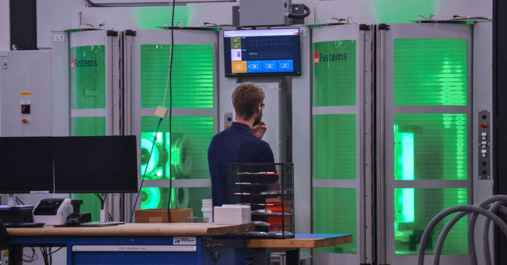 CNC machinist monitors the Fastems FPC as it runs