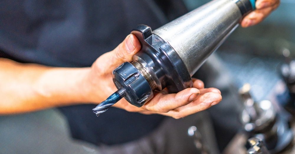 Setup machinist examines an endmill's flute count