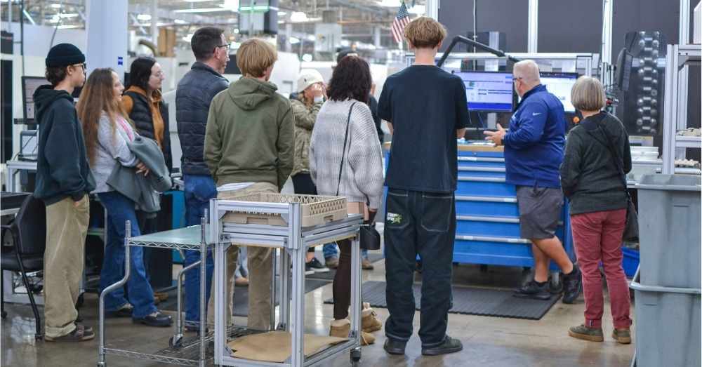 Machinist demonstrates inspection software to visiting students